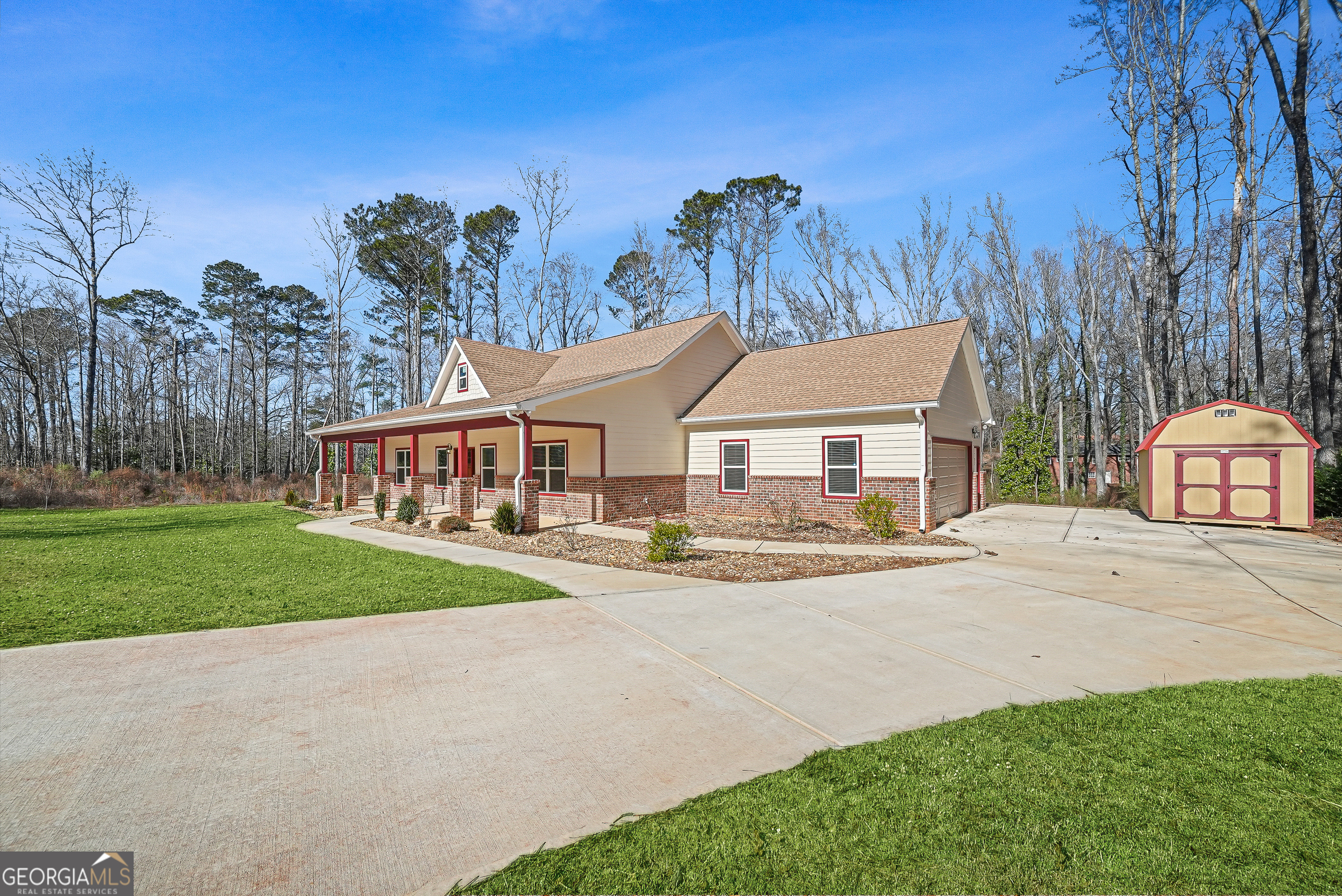 1663 Piedmont Road Griffin, GA 30224 - Photo 3 of 35 a view of a house with garden and trees