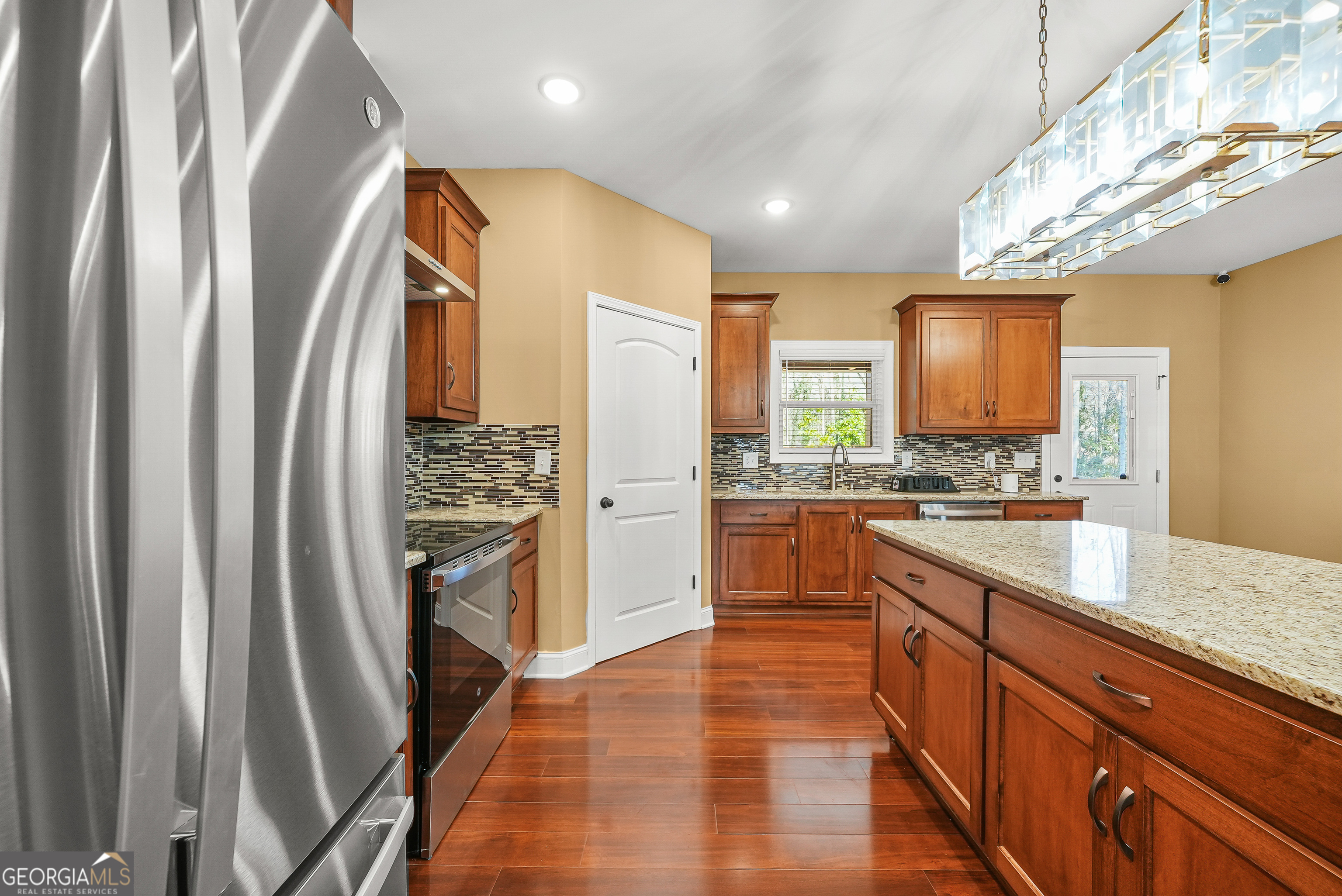 1663 Piedmont Road Griffin, GA 30224 - Photo 9 of 35 a large kitchen with stainless steel appliances a refrigerator and a sink
