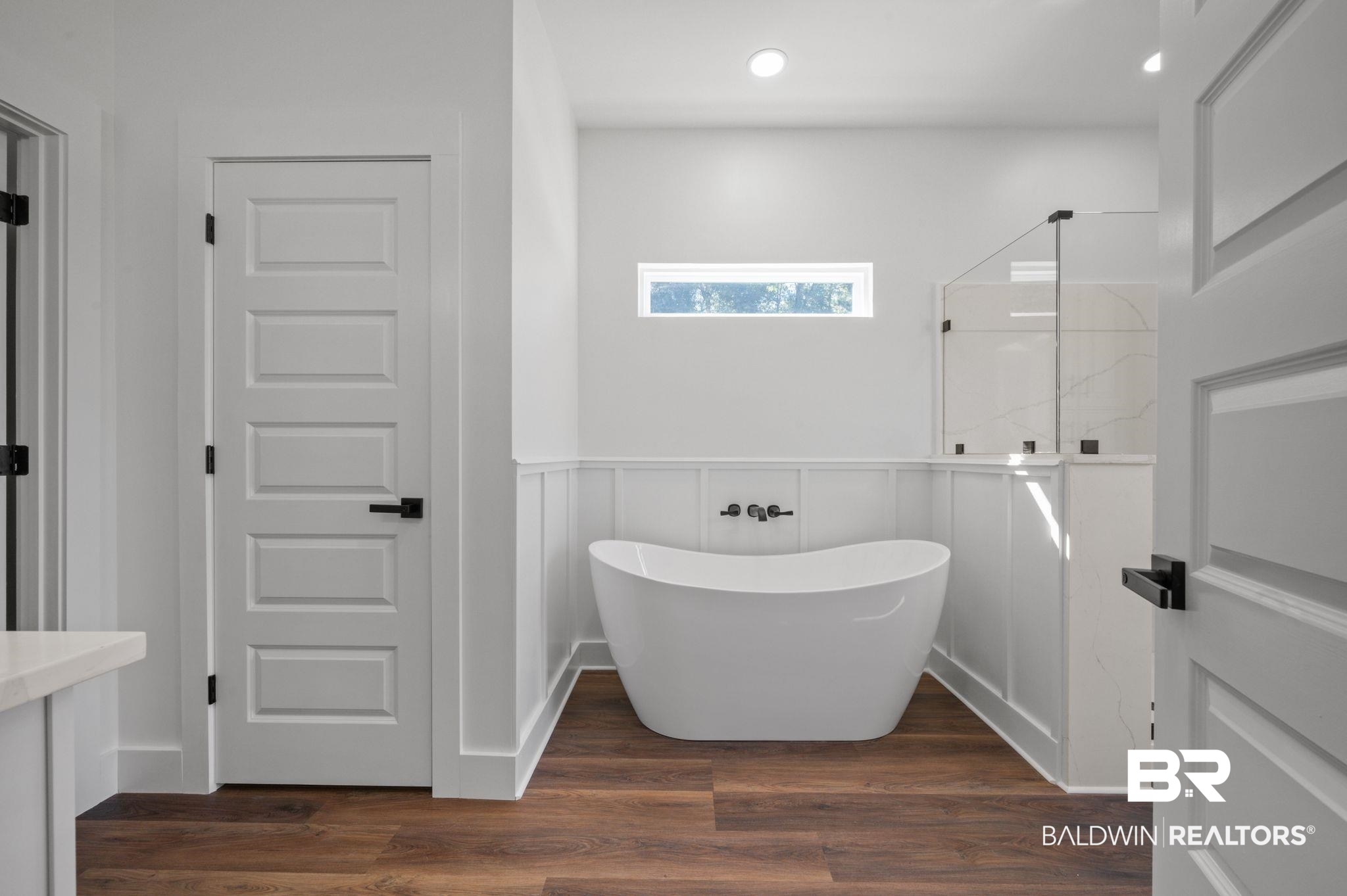 12100 Lott Road Chunchula, AL 36521 - Photo 9 of 21 Bathroom featuring tile walls and wood-type flooring