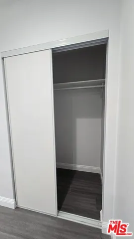 an empty room with wooden floor and window