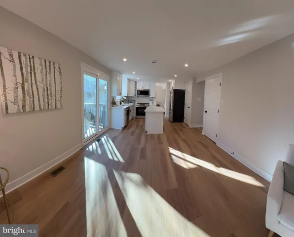 a view of kitchen and center island wooden floor