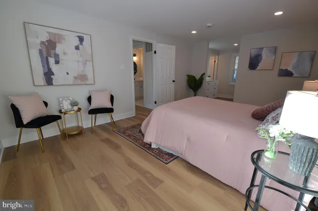 a spacious bedroom with a bed and a chair