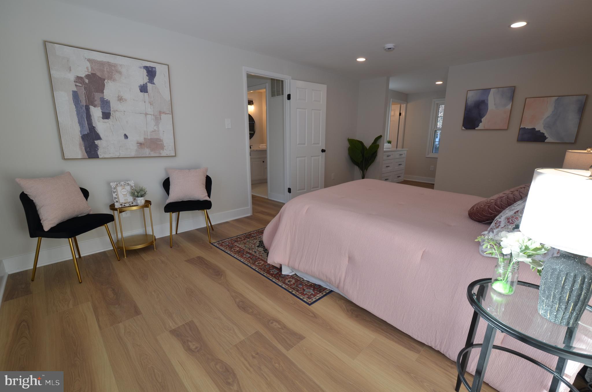 8375 Magic Leaf Road Springfield, VA 22153 - Photo 17 of 43 a spacious bedroom with a bed and a chair