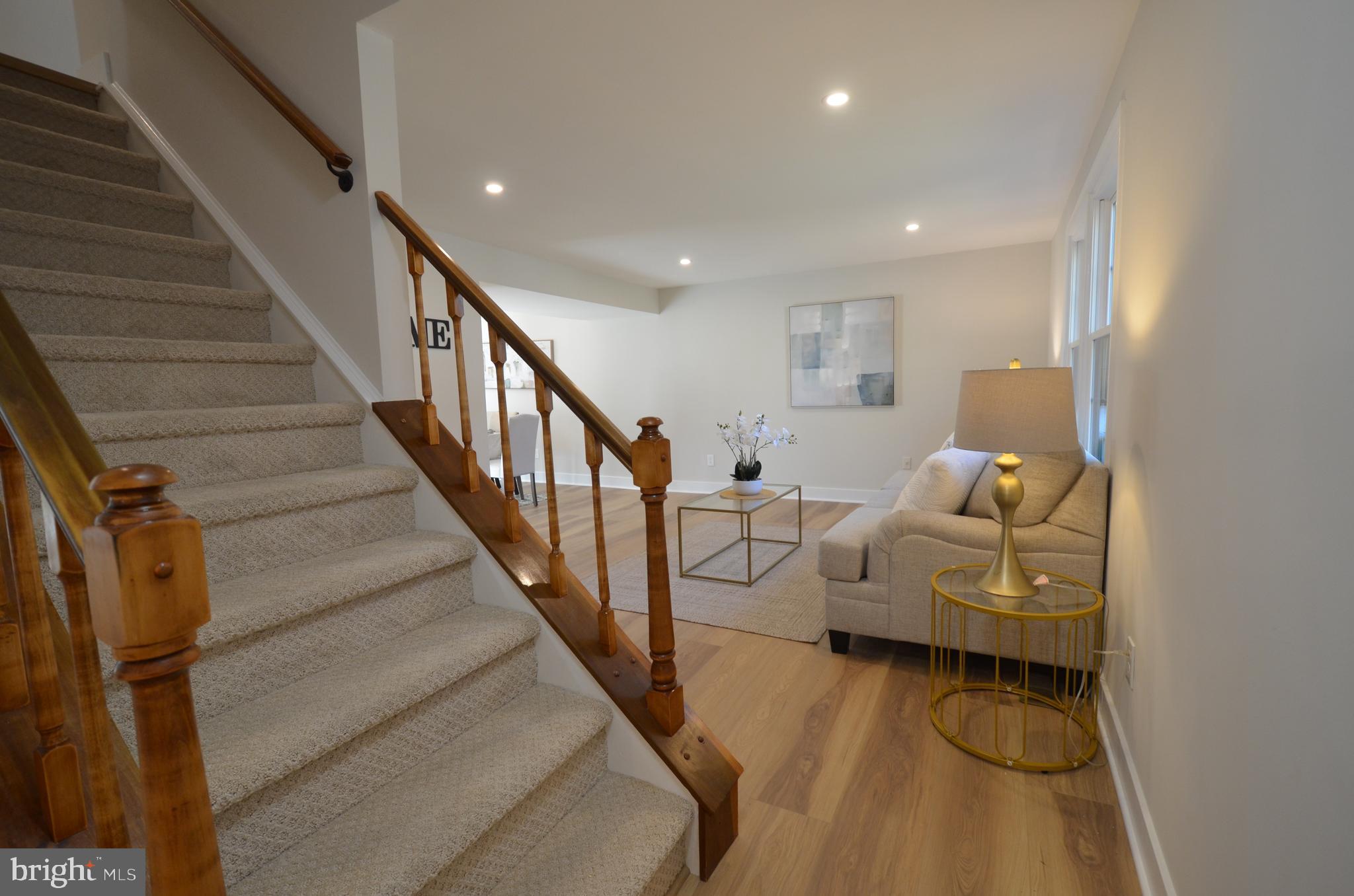 8375 Magic Leaf Road Springfield, VA 22153 - Photo 2 of 43 a living room with furniture and stairs