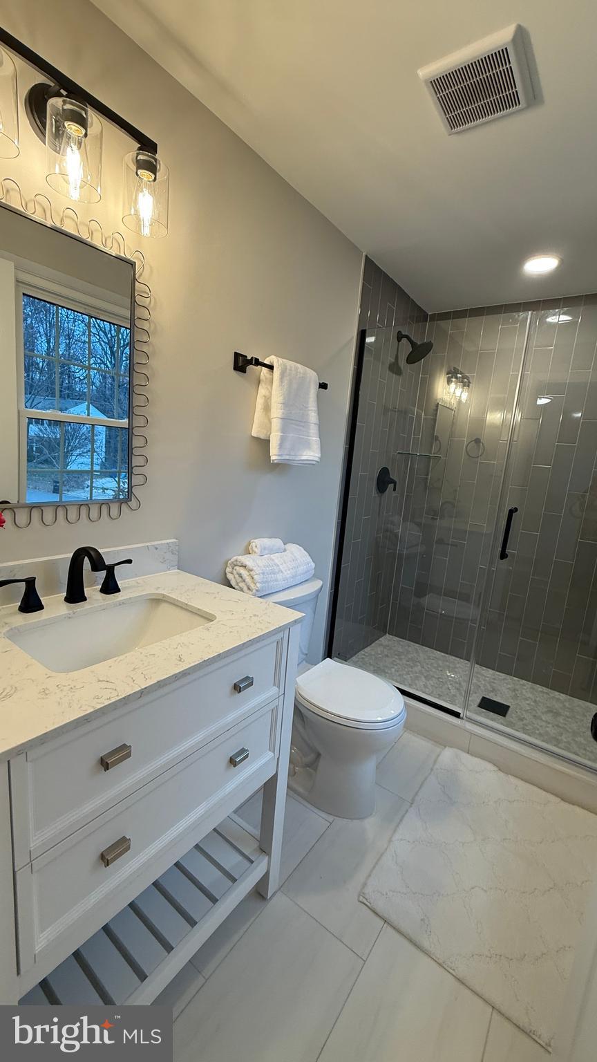 8375 Magic Leaf Road Springfield, VA 22153 - Photo 22 of 43 a bathroom with a sink a toilet and shower
