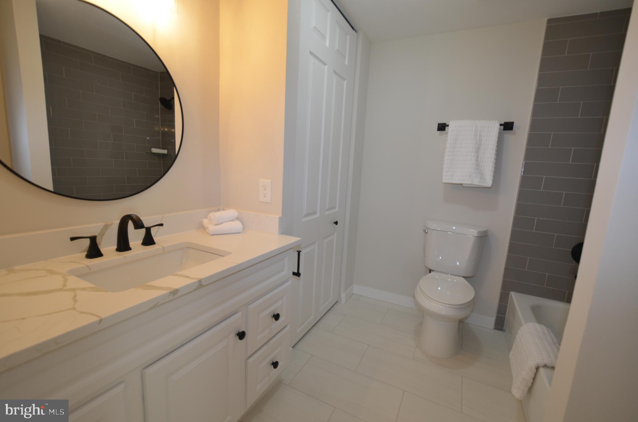8375 Magic Leaf Road Springfield, VA 22153 - Photo 24 of 43 a bathroom with a sink and a mirror