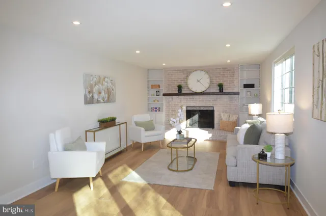 a living room with furniture a fireplace and a table