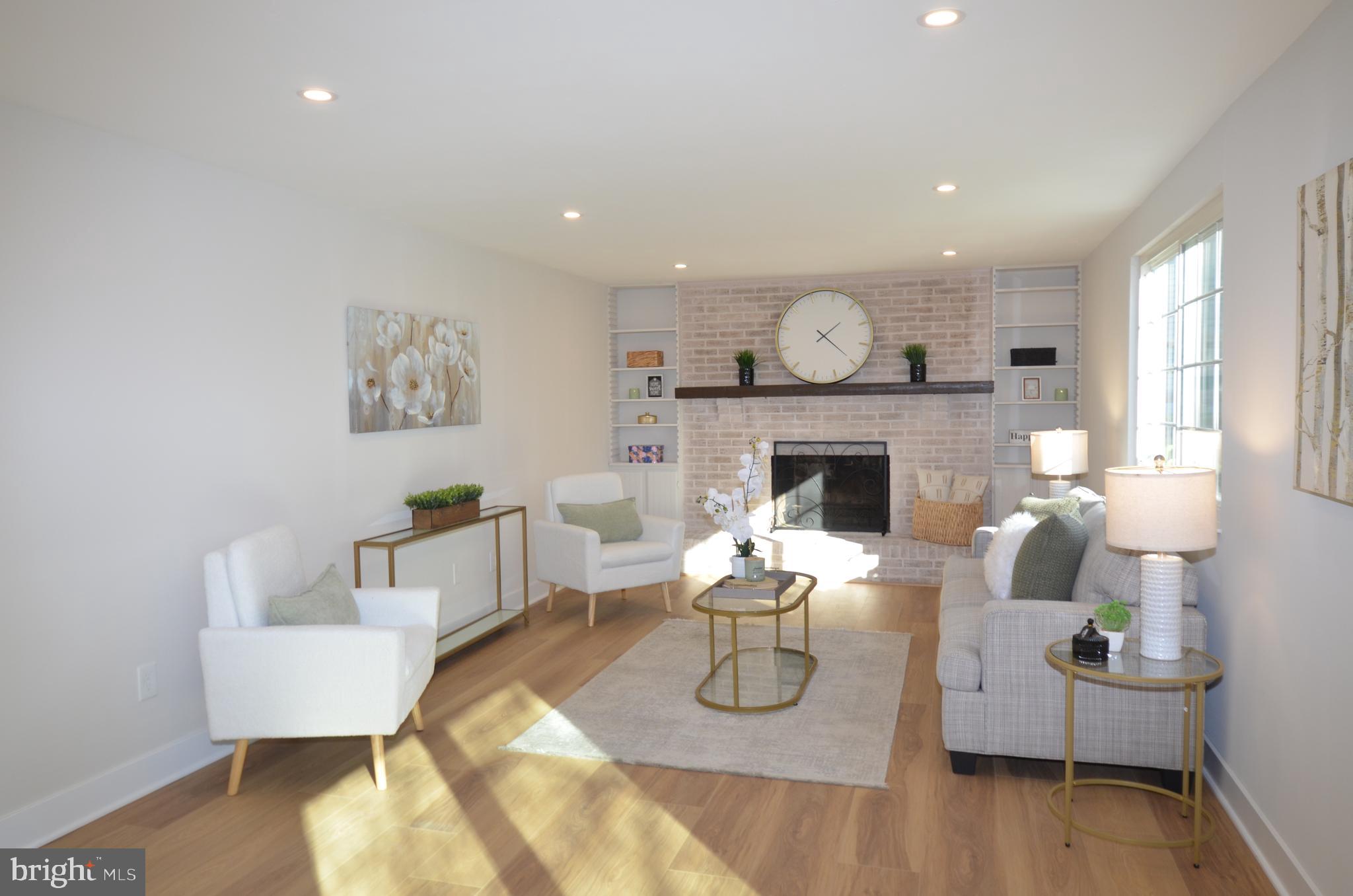 8375 Magic Leaf Road Springfield, VA 22153 - Photo 30 of 43 a living room with furniture a fireplace and a table