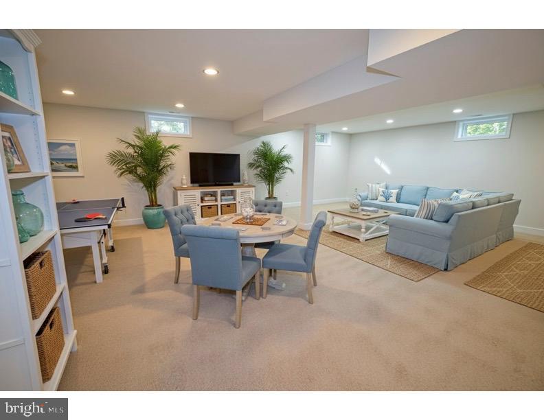 8375 Magic Leaf Road Springfield, VA 22153 - Photo 38 of 43 a living room with furniture a flat screen tv and kitchen view