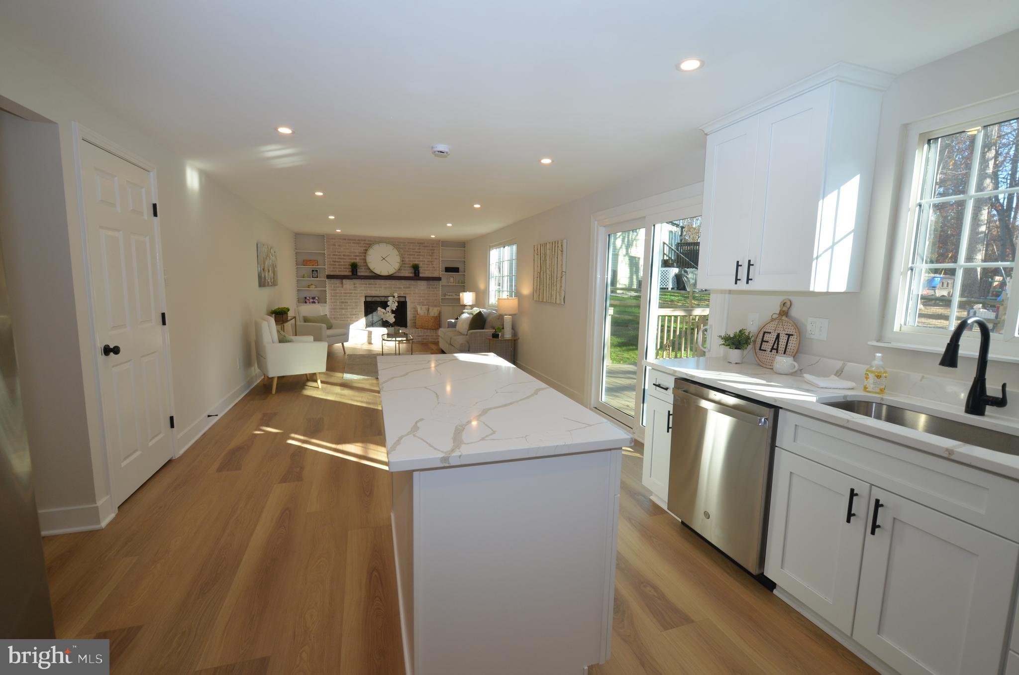8375 Magic Leaf Road Springfield, VA 22153 - Photo 43 of 43 a kitchen with a sink a stove and cabinets