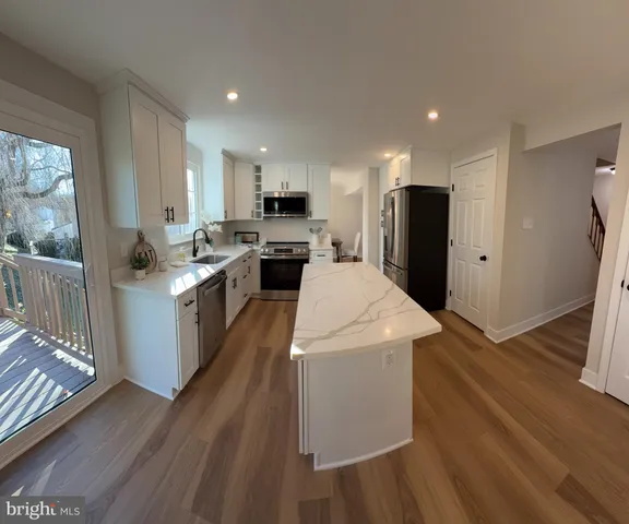 a kitchen with a sink a stove and cabinets