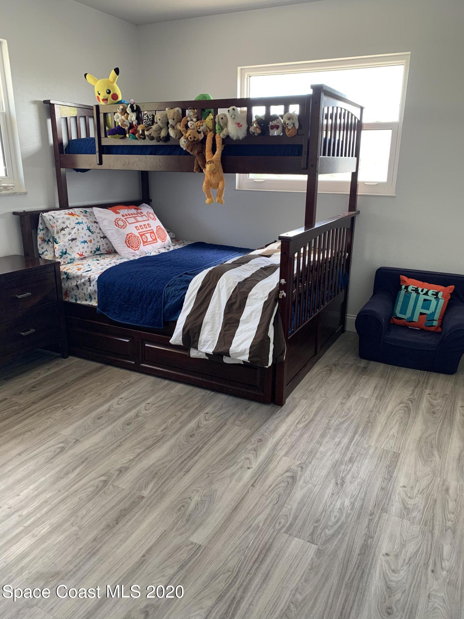 120 Maple Drive Satellite Beach, FL 32937 - Photo 11 of 13 a bedroom with furniture and a wooden floor