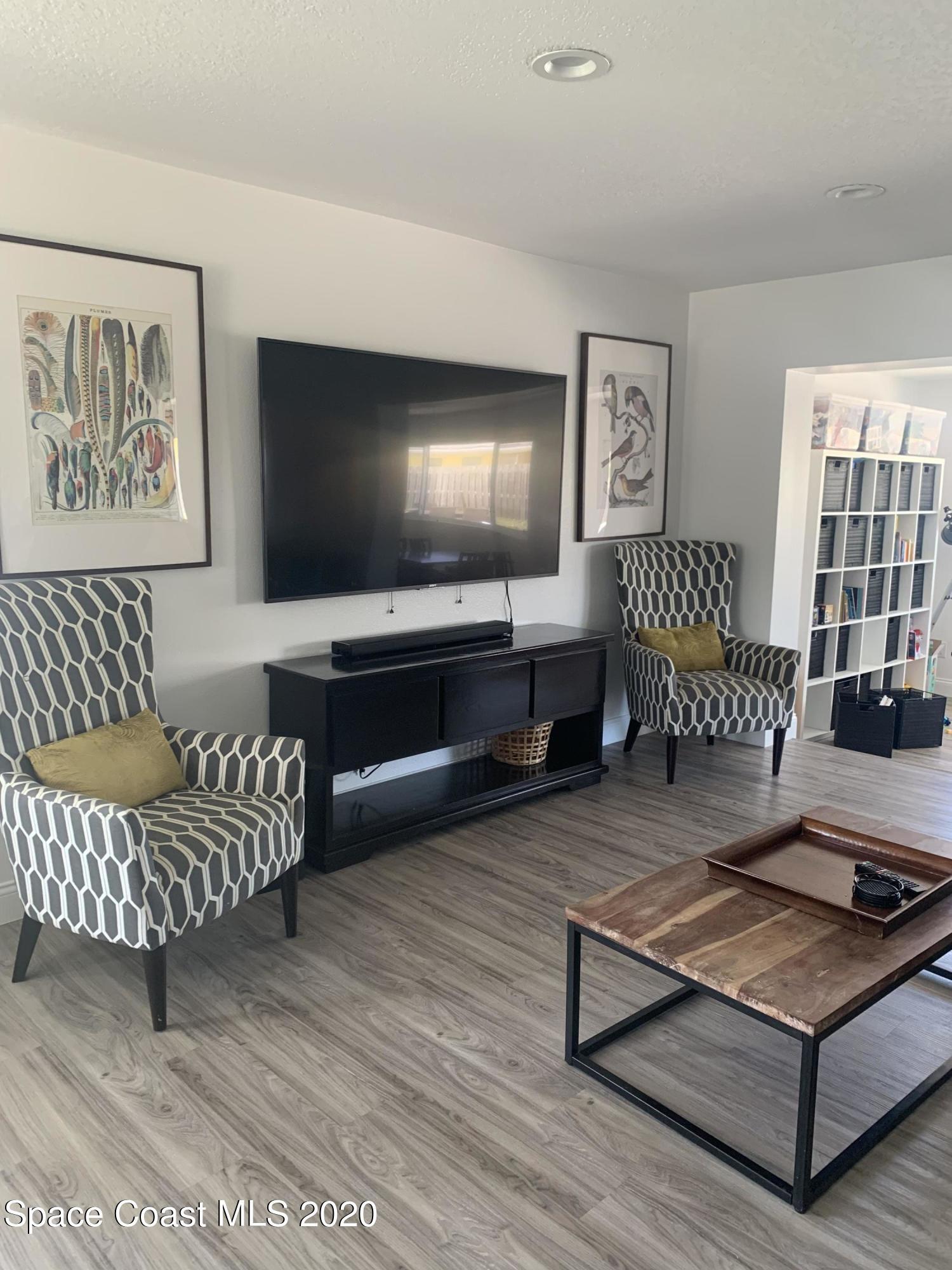 120 Maple Drive Satellite Beach, FL 32937 - Photo 2 of 13 a living room with furniture and a flat screen tv