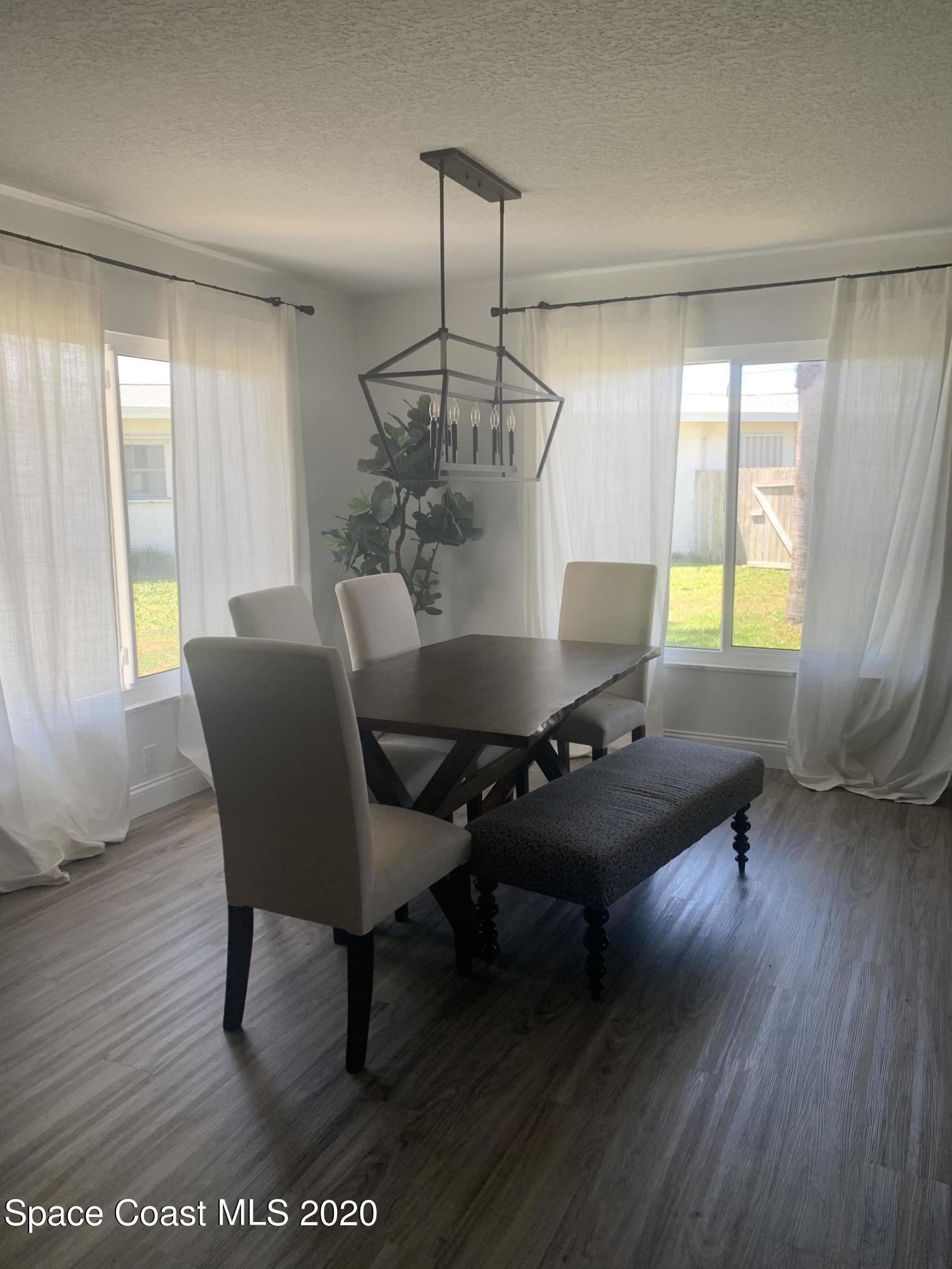120 Maple Drive Satellite Beach, FL 32937 - Photo 6 of 13 a living room with furniture and a wooden floor