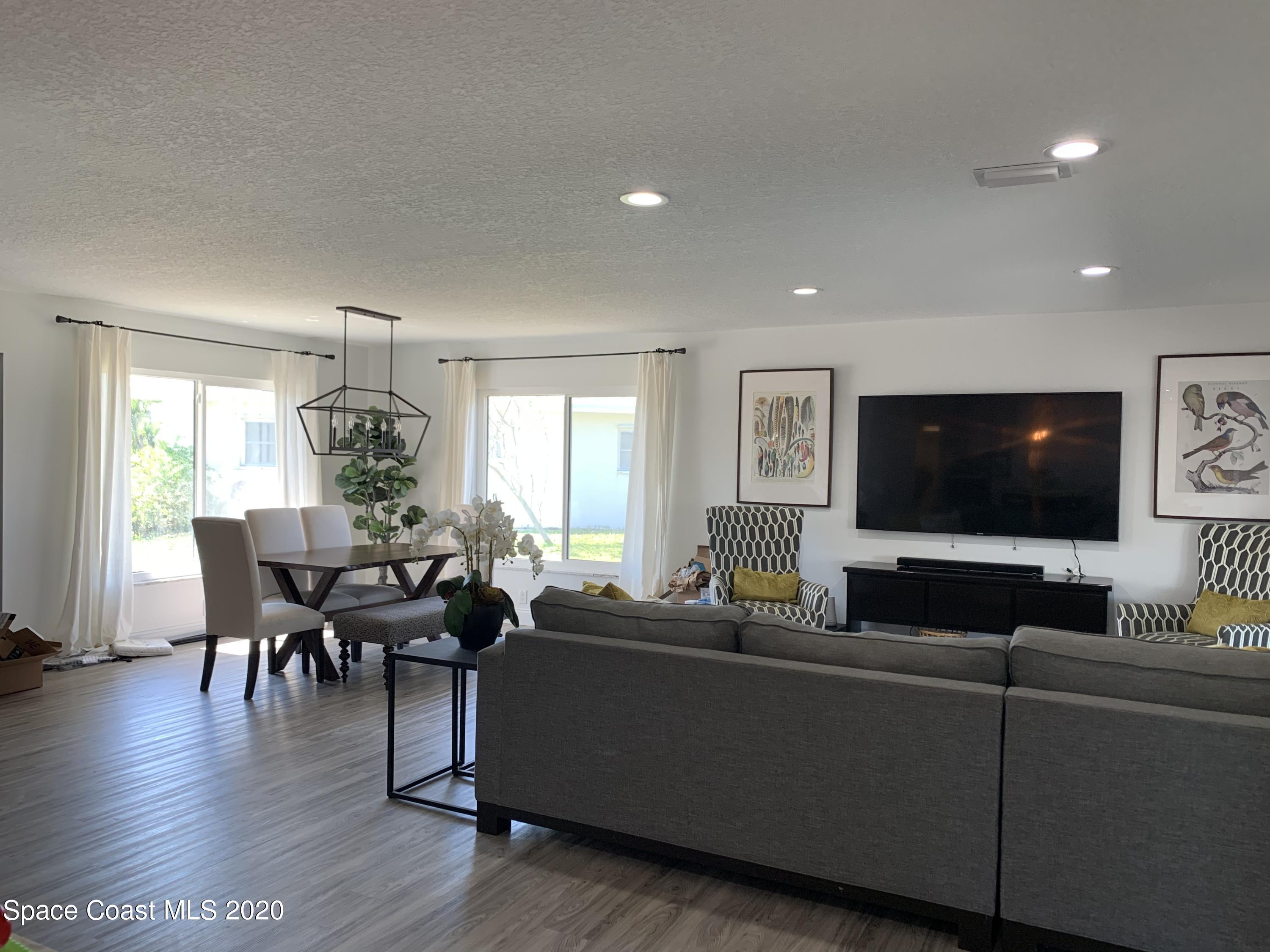 120 Maple Drive Satellite Beach, FL 32937 - Photo 7 of 13 a living room with furniture and a flat screen tv