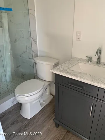 a white toilet sitting next to a bathroom sink