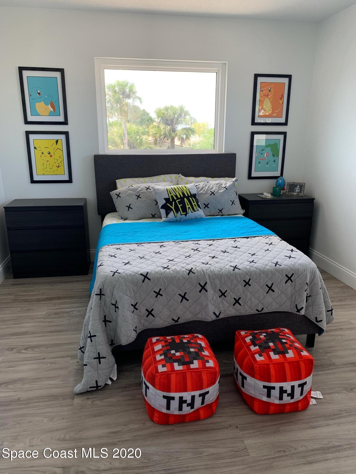 120 Maple Drive Satellite Beach, FL 32937 - Photo 10 of 13 a bedroom with a bed mirror and window