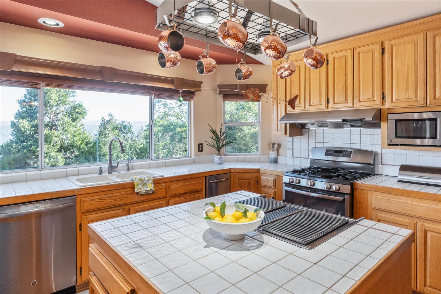 4480 Foster Court Murphys, CA 95247 - Photo 10 of 57 The great room opens to a kitchen loaded with stainless appliances -- party-size fridge, trash compactor, instant hot tap, super quiet disposal, and hardwood floors throughout the kitchen and dining areas.