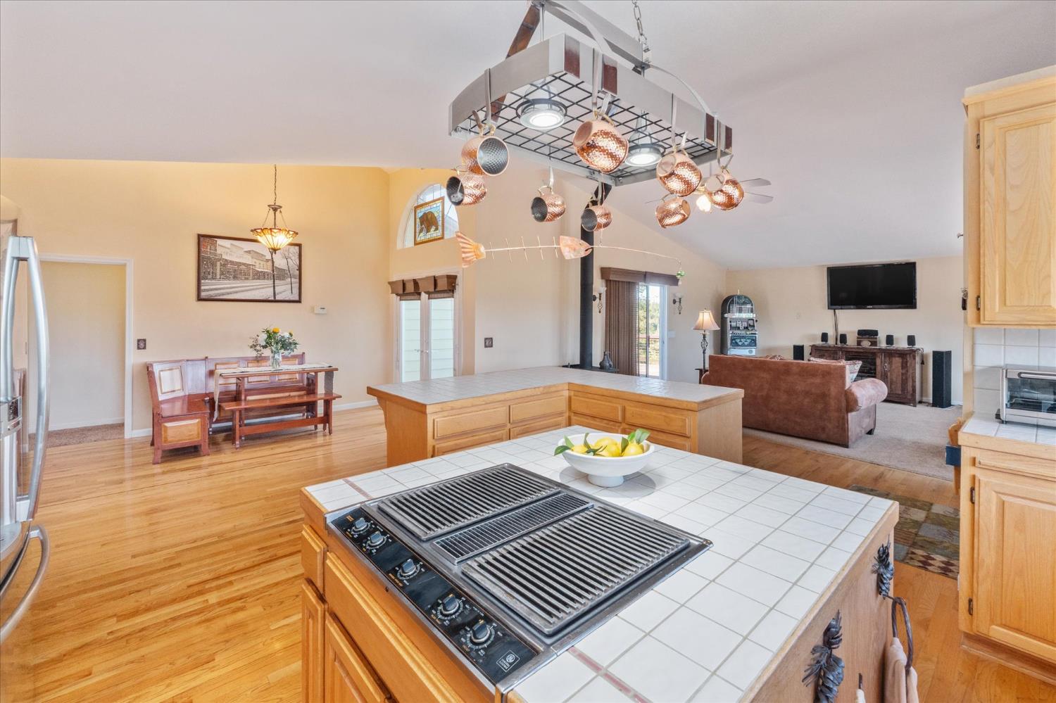 4480 Foster Court Murphys, CA 95247 - Photo 11 of 57 The great room opens to a kitchen loaded with stainless appliances -- party-size fridge, trash compactor, instant hot tap, super quiet disposal, and hardwood floors throughout the kitchen and dining areas.
