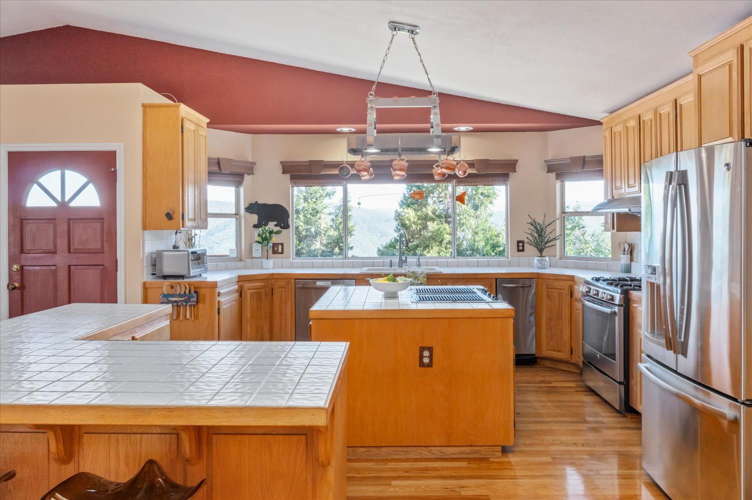 4480 Foster Court Murphys, CA 95247 - Photo 12 of 57 The great room opens to a kitchen loaded with stainless appliances -- party-size fridge, trash compactor, instant hot tap, super quiet disposal, and hardwood floors throughout the kitchen and dining areas.