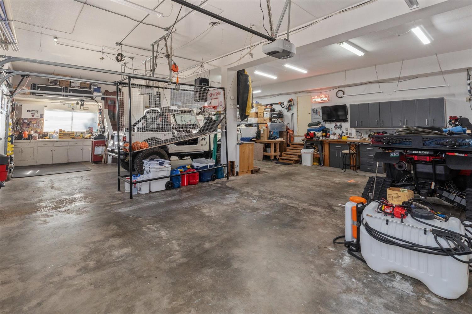 4480 Foster Court Murphys, CA 95247 - Photo 32 of 57 Ultimate 25’ deep 3-car workshop with custom cabinetry, three workbenches, and a stainless sink. Beyond what meets the eye are numerous hidden storage areas—there is simply no shortage of storage here! Extensive inventory of high-quality tools and equipment included.