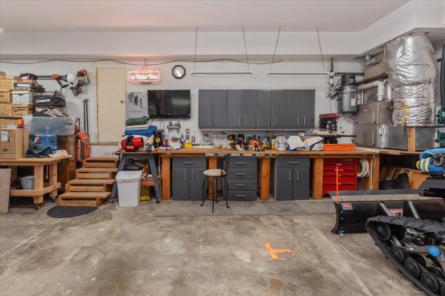 4480 Foster Court Murphys, CA 95247 - Photo 33 of 57 Ultimate 25’ deep 3-car workshop with custom cabinetry, three workbenches, and a stainless sink. Beyond what meets the eye are numerous hidden storage areas—there is simply no shortage of storage here! Extensive inventory of high-quality tools and equipment included.