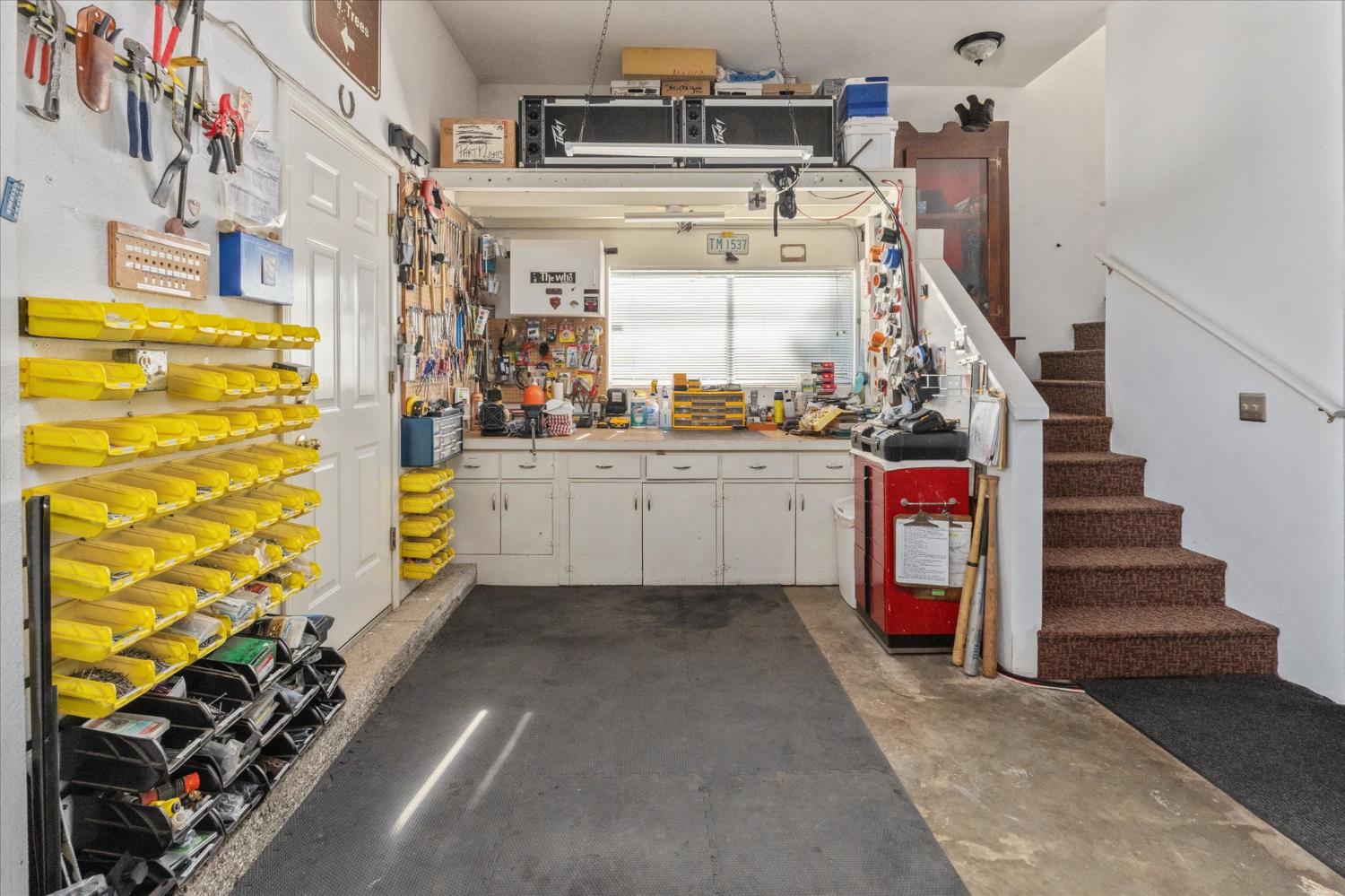 4480 Foster Court Murphys, CA 95247 - Photo 34 of 57 Ultimate 25’ deep 3-car workshop with custom cabinetry, three workbenches, and a stainless sink. Beyond what meets the eye are numerous hidden storage areas—there is simply no shortage of storage here! Extensive inventory of high-quality tools and equipment included.