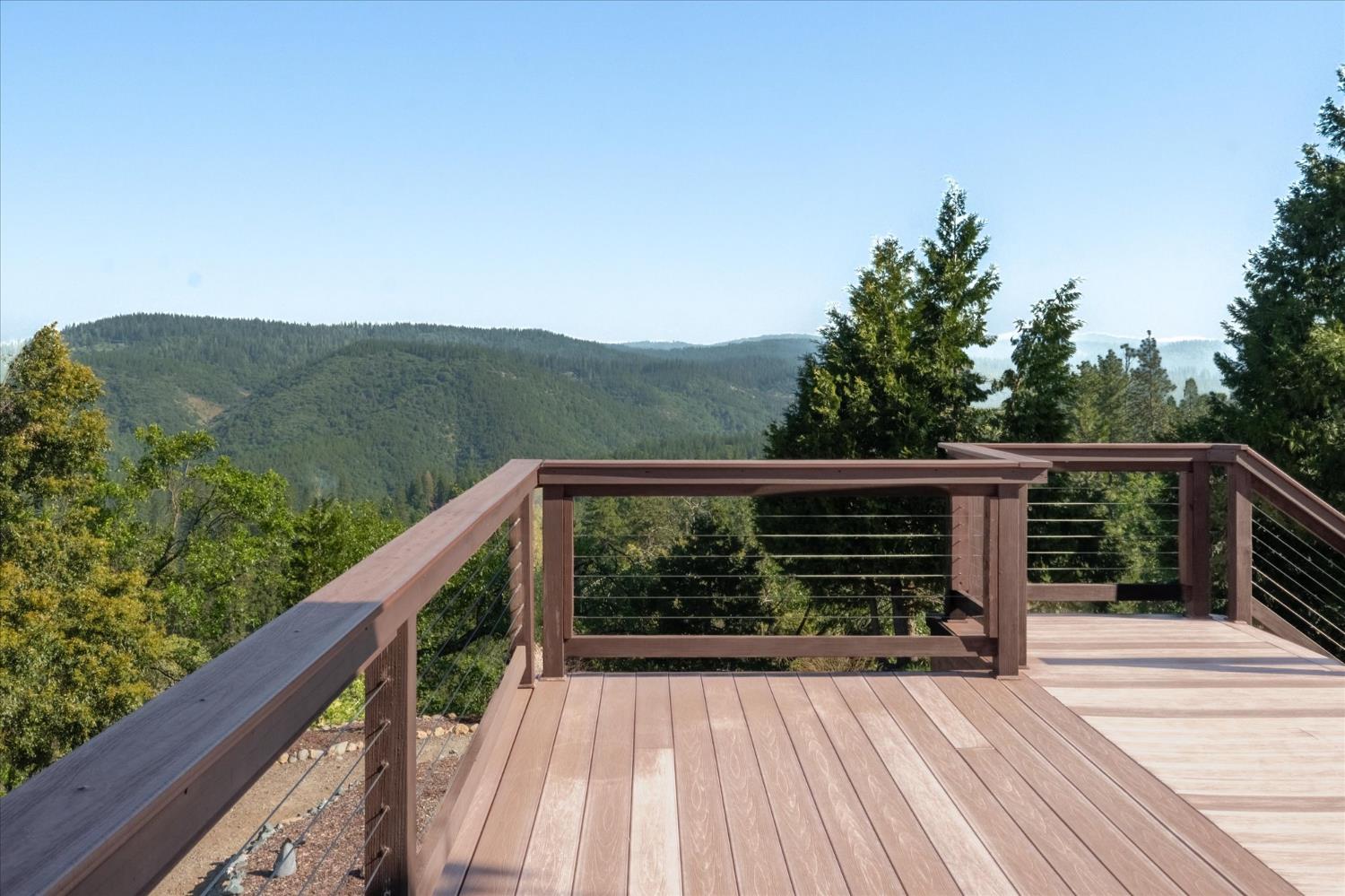 4480 Foster Court Murphys, CA 95247 - Photo 35 of 57 Outside, the property truly opens up. Two wraparound composite decks with stainless cable railing, underlighting, and step lights.