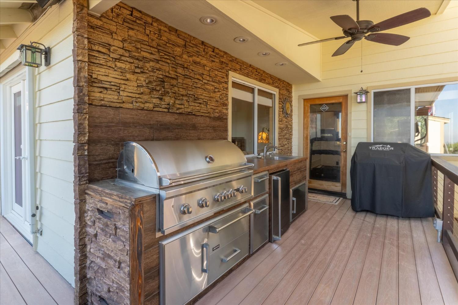 4480 Foster Court Murphys, CA 95247 - Photo 5 of 57 A built-in outdoor kitchen with 42" propane BBQ, fridge, stainless sink, and recessed LED lighting.