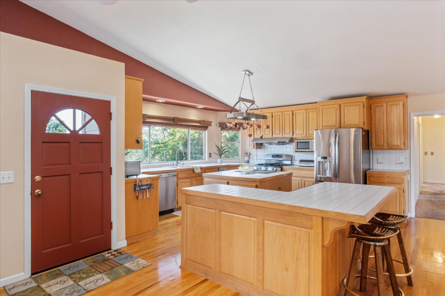 4480 Foster Court Murphys, CA 95247 - Photo 9 of 57 The great room opens to a kitchen loaded with stainless appliances -- party-size fridge, trash compactor, instant hot tap, super quiet disposal, and hardwood floors throughout the kitchen and dining areas.