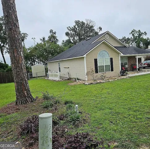 a front view of house with yard and green space