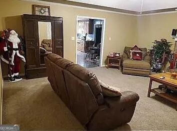 a living room with furniture and a gym machine