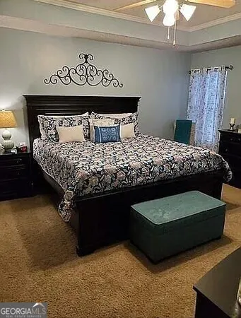 a bedroom with a bed and a dresser