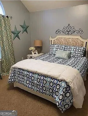 a large bed sitting next to a window