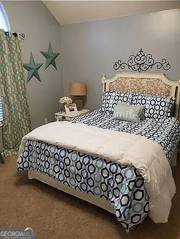 a large bed sitting next to a window