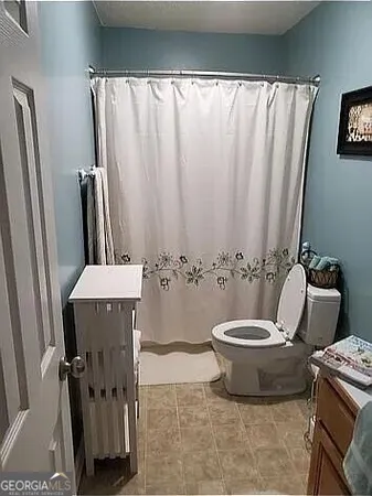 a bathroom with a toilet and a sink