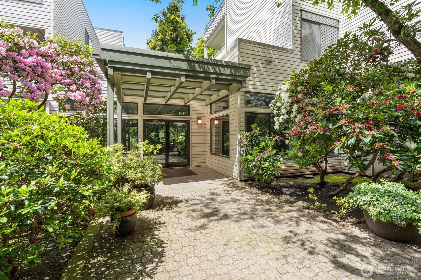 211 Summit Avenue East, Unit S218 Seattle, WA 98102 - Photo 15 of 19 a front view of a house with a garden