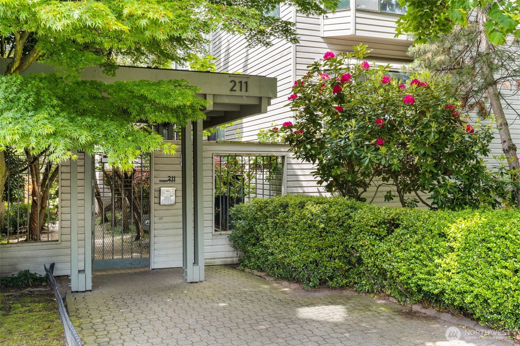 211 Summit Avenue East, Unit S218 Seattle, WA 98102 - Photo 16 of 19 a view of a house with a flower garden