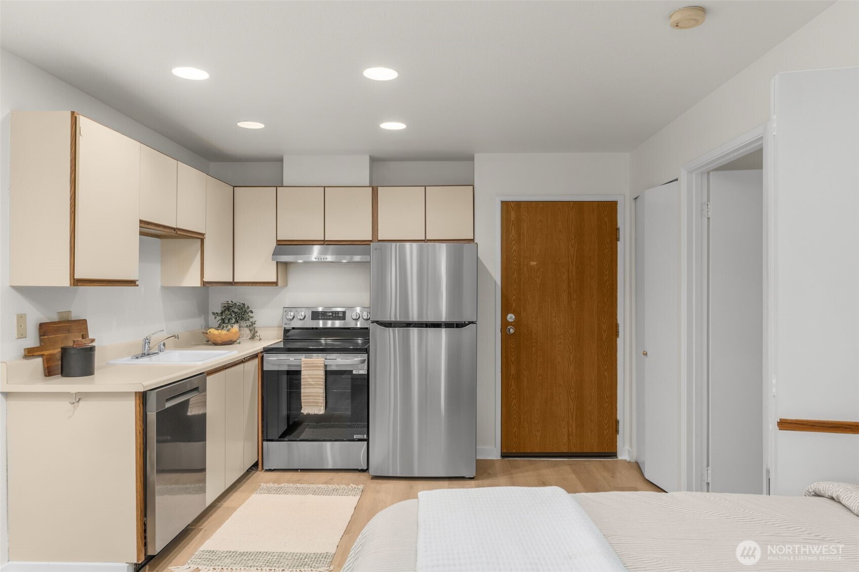 211 Summit Avenue East, Unit S218 Seattle, WA 98102 - Photo 17 of 19 a kitchen with stainless steel appliances granite countertop a refrigerator sink and cabinets