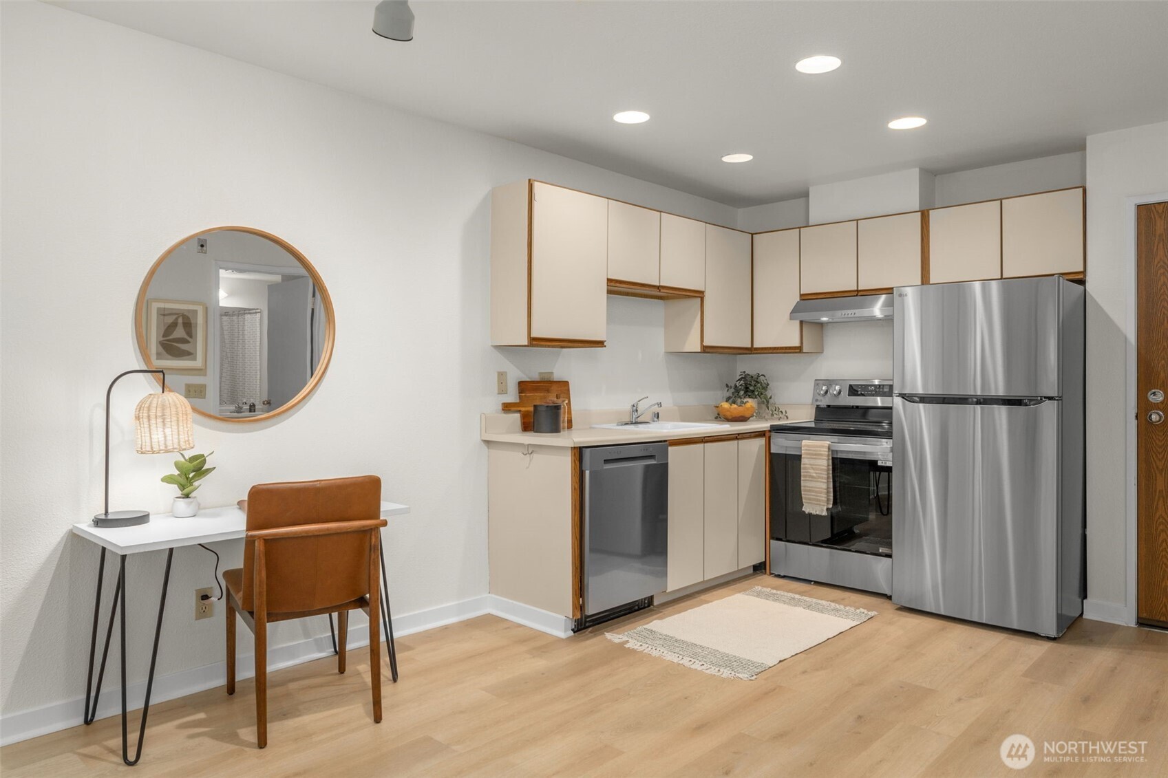 211 Summit Avenue East, Unit S218 Seattle, WA 98102 - Photo 4 of 19 a kitchen with stainless steel appliances granite countertop a refrigerator and a stove top oven