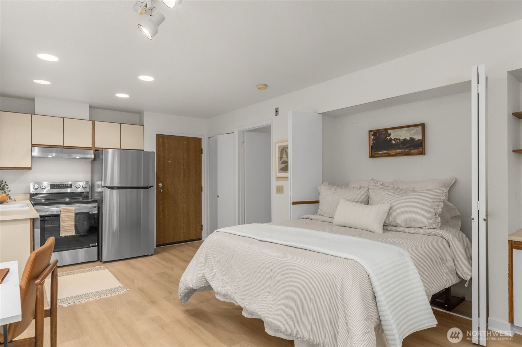 211 Summit Avenue East, Unit S218 Seattle, WA 98102 - Photo 9 of 19 a bedroom with a bed and a refrigerator