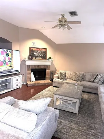 a living room with furniture and a fireplace