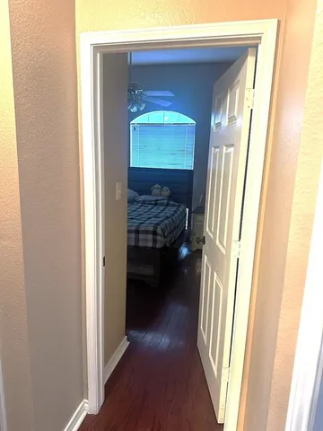 a view of a hallway and a livingroom with wooden floor