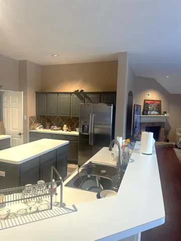 a kitchen with a sink and a refrigerator