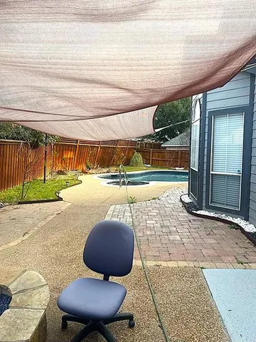 a view of a swimming pool with a patio