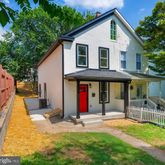 a front view of a house with a yard and porch