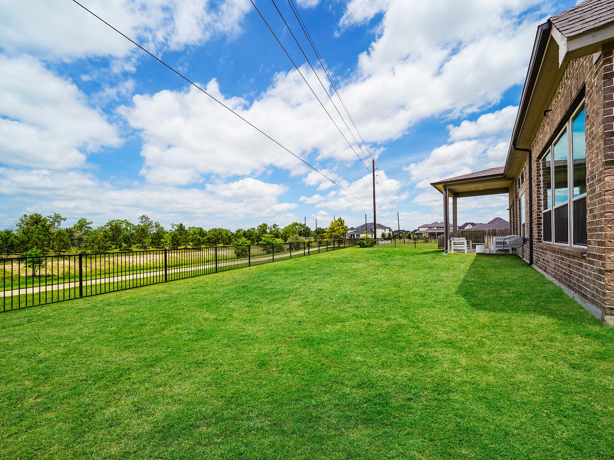 5802 Emerald Ranch Lane Fulshear, TX 77441 - Photo 43 of 45 The expansive backyard provides endless possibilities with ample room to add a future pool, outdoor kitchen, or customized entertaining space while still maintaining generous green space.