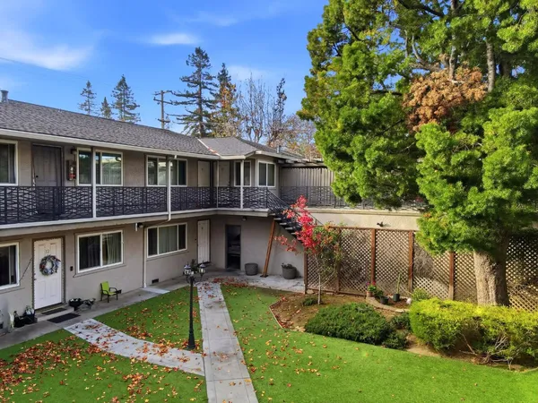 a front view of a house with a garden