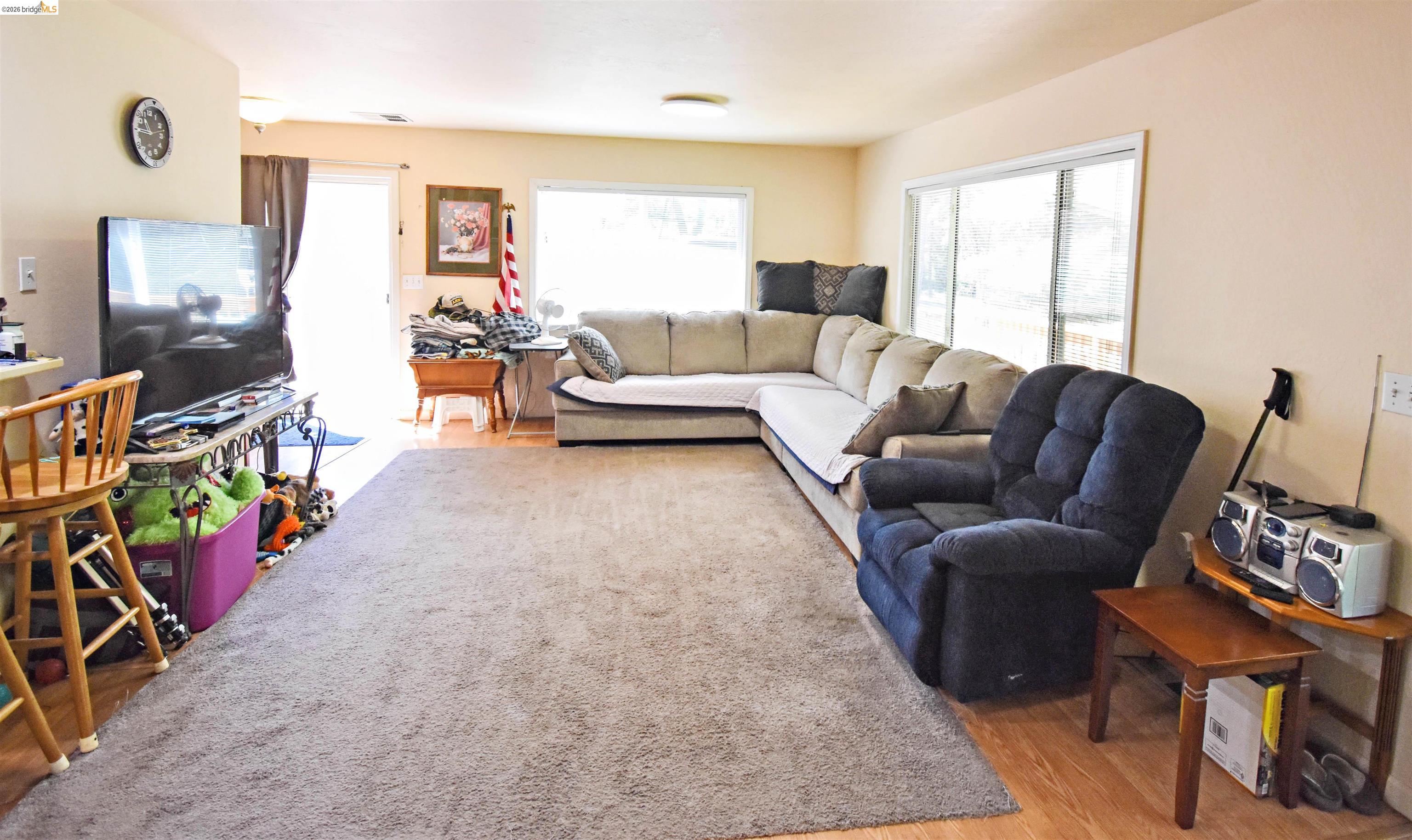 13904 Tuolumne Road Sonora, CA 95370 - Photo 16 of 44 Living area featuring wood-finish flooring, neutral wall tones, and large windows providing abundant natural light