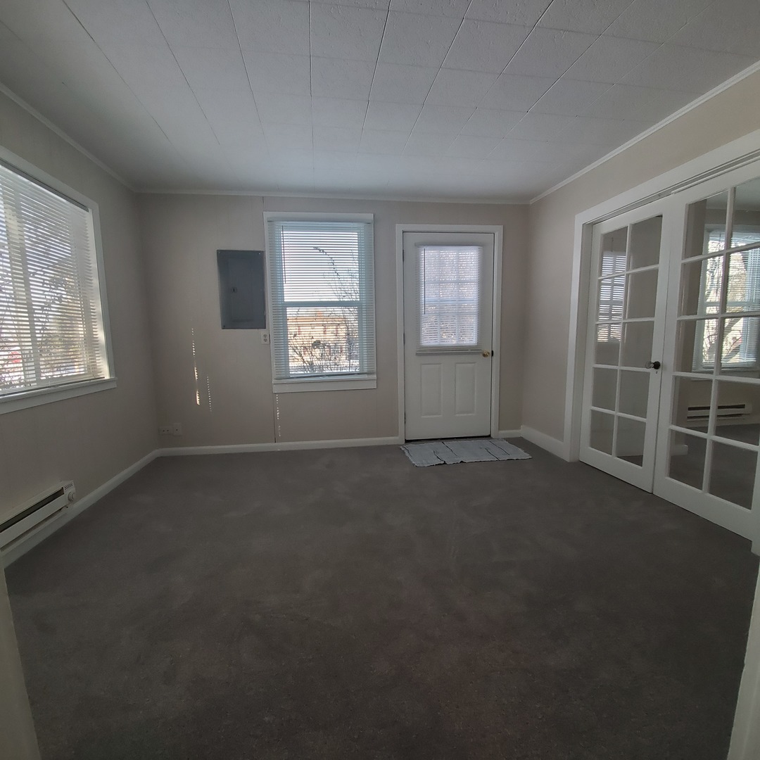 6020 Hickory Street Harvard, IL 60033 - Photo 3 of 17 an empty room with windows